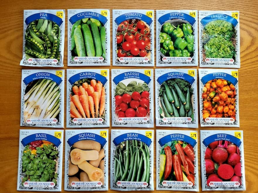 A selection of vegetable seed packets displayed on a wooden table